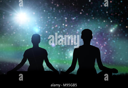 black silhouette of couple meditating over space Stock Photo