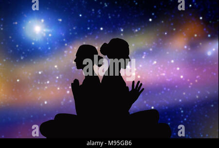 black silhouette of couple meditating over space Stock Photo