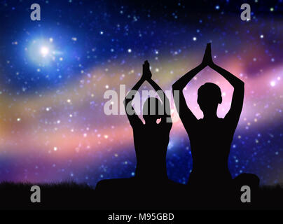 black silhouette of couple meditating over space Stock Photo