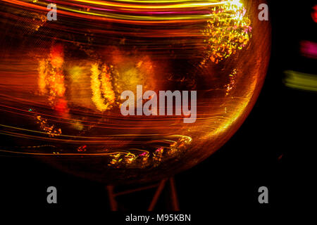 An abstract close-up of bauble, motion in camera causing the light being dragged across its spherical shape. Stock Photo