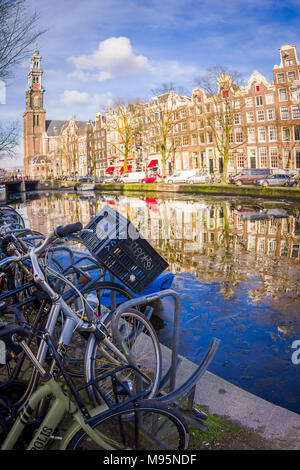 AMSTERDAM, NETHERLANDS, MARCH, 10 2018: Outdoor view of bycicles parked at the bridge in Amsterdam Stock Photo