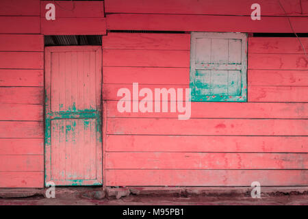 front of old wooden house - pink, vintage wooden hut - Stock Photo