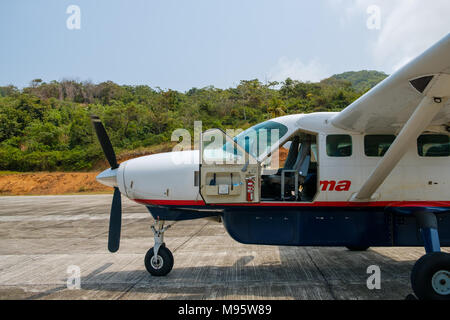 Puerto Obaldia, Panama - March 2018: Small  Cessna 208B propeller airplane from Air Panama with open cockpit door Stock Photo