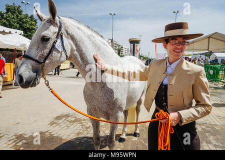 Cordoba, Andalusia, Spain : Andalusian horsewoman and thoroughbred mare at the Cordoba Horse Fair. Stock Photo