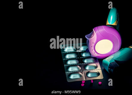 Set of asthma inhaler, accuhaler and anti-allergy pills for treatment asthma. Asthma controller, reliever equipment on dark background with space. Bro Stock Photo