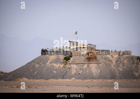 Afghan National Defence and Security Forces' outpost, flying in the Afghan national flag, somewhere close to the main road in Farah province. Afghanistan’s elite military forces – the Commandos and the Special Forces are one of the key elements in the Afghan and U.S. strategy to turn the grinding fight against the Taliban and other insurgents around. These pictures show the Commandos and Special Forces during training and in the field; also right before and after an operation in the restive western Afghan province of Farah. Stock Photo