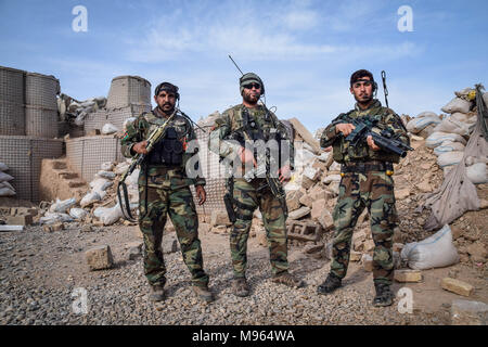 Afghan Commandos in the remains of an Afghan National Defence and Security Forces outpost behind Farahrud Bazaar, just off the main road in Bolo Bluk district, Farah province. According to the Commandos, the outpost had been recently overrun and razed by Taliban who hold the village just outside. Afghanistan’s elite military forces – the Commandos and the Special Forces are one of the key elements in the Afghan and U.S. strategy to turn the grinding fight against the Taliban and other insurgents around. These pictures show the Commandos and Special Forces during training and in the field; also Stock Photo