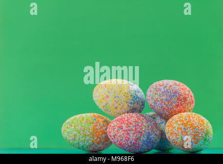 multicolor decorated easter eggs in line on colorful background Stock Photo