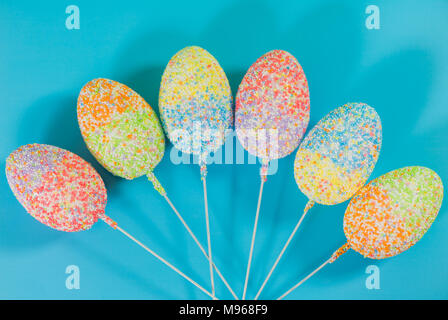 multicolor decorated easter eggs in line on colorful background Stock Photo