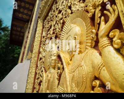 The Couple, Golden Wall Stucco on The Doo in Xiang Thong Temple, Luang Prabang, Laos Stock Photo