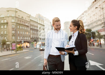 Businesspeople commuting and walking in city Stock Photo