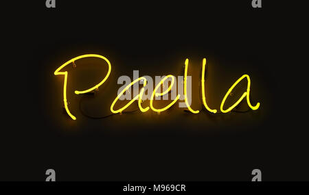 Close up PAELLA yellow neon light sign glowing in the dark over black wall background Stock Photo