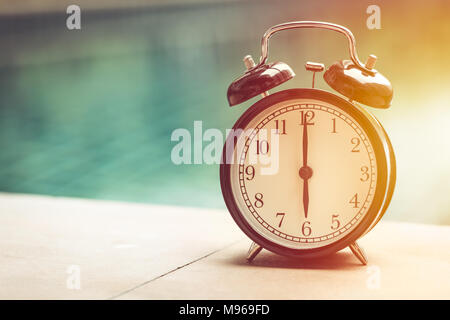 afternoon times clock with blur water park background vintage colortone Stock Photo