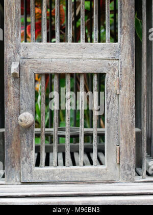 Door of empty wooden bird cage in retro style show concepts of entrance, taking chance, security, conceptual and imagination block, and trap Stock Photo