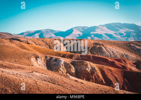 Colored mountains under the blue sky. Red hills of Kyzyl-Chin, Altai. Martian landscape. Red canyon. Stock Photo
