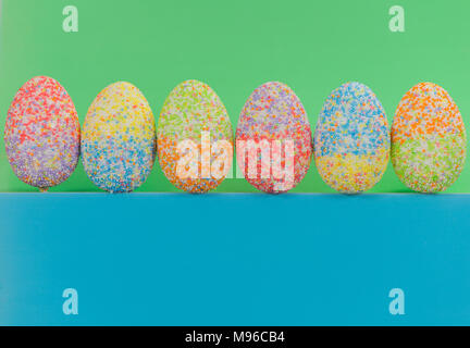 multicolor decorated easter eggs in line on colorful background Stock Photo