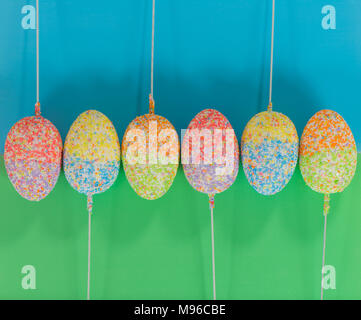 multicolor decorated easter eggs in line on colorful background Stock Photo