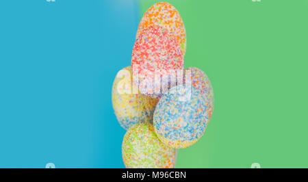 multicolor decorated easter eggs in line on colorful background Stock Photo