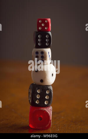top view detail closeup of pile of many different color and sizes vintage used rolling dices on wooden background Stock Photo