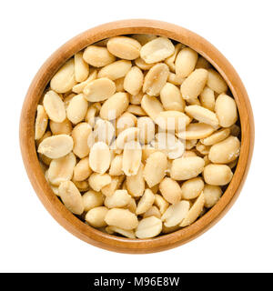 Peanuts, roasted and salted, in wooden bowl. Shelled Arachis hypogaea, also called groundnut and goober, used as a snack. Stock Photo