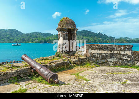 Old Spanish cannon at the fortress ruin of Santiago with a view over the Caribbean Sea in Portobelo near Colon, Panama, Central America. Stock Photo