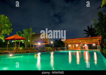 Indonesia. Night in the jungle. Empty pool and bar in the hotel Stock Photo