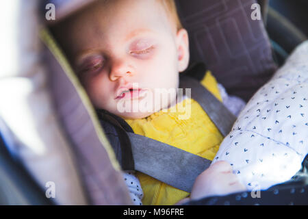 Child asleep in car seat Stock Photo