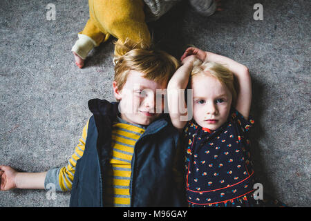 Brother and Sister laying next to each other Stock Photo