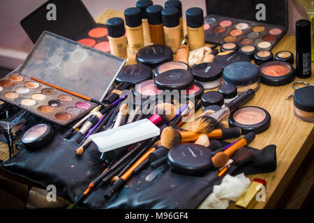make up products spread out on table being used on bride before wedding Stock Photo