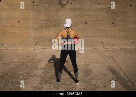 Woman holding basketball in the basketball court Stock Photo