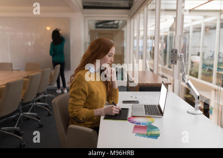 Female graphic designer using graphics tablet Stock Photo
