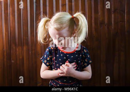 Girl with pigtails pulling faces Stock Photo