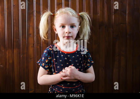 Girl with pigtails pulling faces Stock Photo