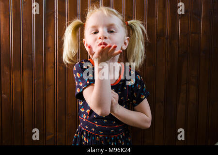 Girl with pigtails pulling faces Stock Photo