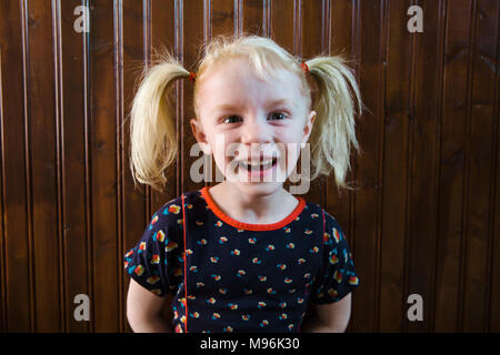 9 Year Old Laughing Little girl with freckles smiling and laughing at the 