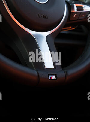 21 March 2018 - London, England. Vertical close-up of BMW Motorsport logo badge on the steering wheel. Stock Photo