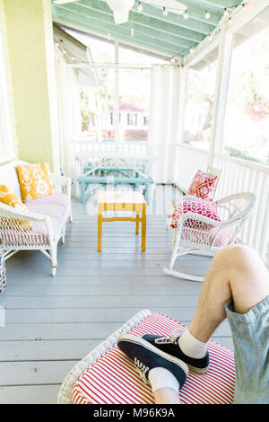 Man laying down on porch Stock Photo