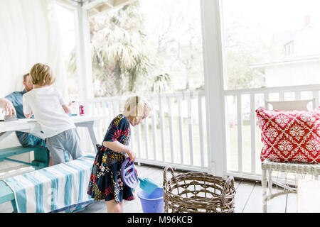 Family sitting/standing on porch Stock Photo