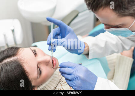 Dentist makes an anesthetic injection for the patient Stock Photo