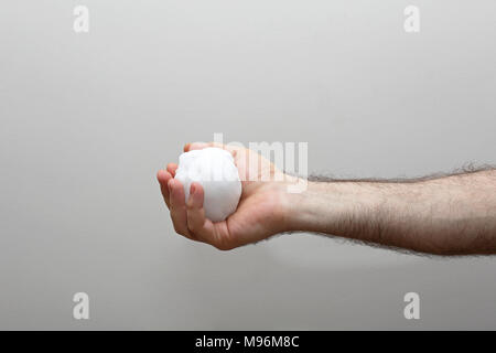 Man Holding Snowball in Hairy Hand Stock Photo