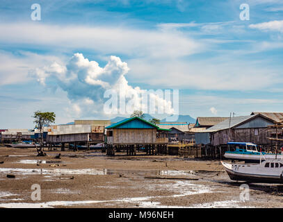 Village of Sea Gypsies during low tide. Asian traditional wooden houses on stilts. Floating houses village in Maumere, Flores Island, Indonesia Stock Photo