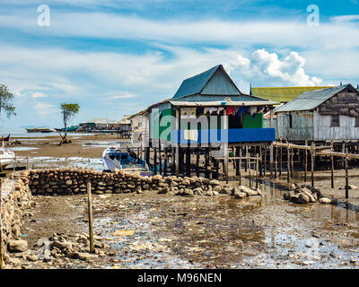 Village of Sea Gypsies during low tide. Asian traditional wooden houses on stilts. Floating houses village in Maumere, Flores Island, Indonesia Stock Photo