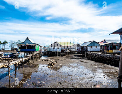Village of Sea Gypsies during low tide. Asian traditional wooden houses on stilts. Floating houses village in Maumere, Flores Island, Indonesia Stock Photo