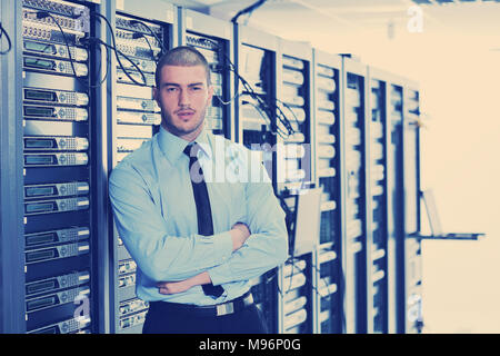 young engeneer business man with thin modern aluminium laptop in network server room Stock Photo