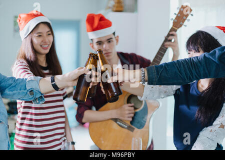 Asian group of friends having party with alcoholic beer drinks and Young people enjoying at a bar toasting cocktails.soft focus Stock Photo