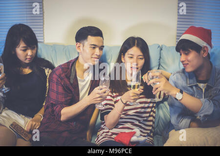 Asian group of friends having party with alcoholic beer drinks and Young people enjoying at a bar toasting cocktails.soft focus Stock Photo
