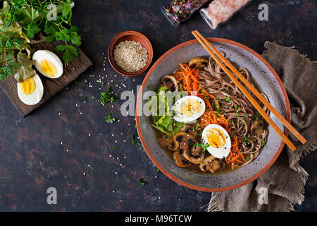 Japanese miso ramen noodles with eggs, carrot and mushrooms. Soup delicious food. Flat lay. Top view Stock Photo