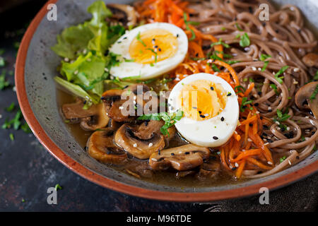Japanese miso ramen noodles with eggs, carrot and mushrooms. Soup delicious food. Stock Photo