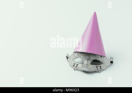 close up view of masquerade mask and party cone isolated on grey Stock Photo