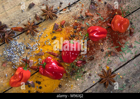 Hot chili peppers on a rustic farmhouse table. Used to add a hot spicy flavor to cooking. Stock Photo